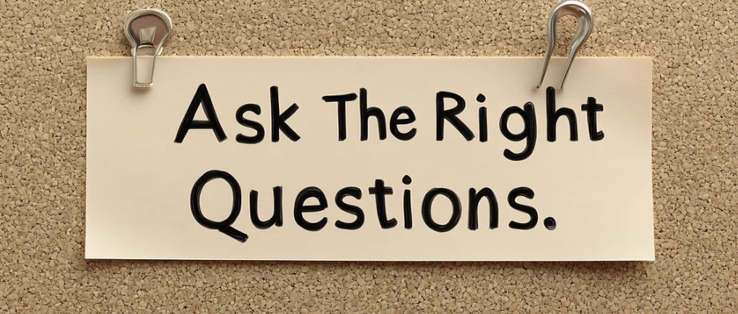 A corkboard sign that reads “Ask The Right Questions,” representing a thoughtful, evidence-based approach to injury recovery and rehabilitation massage therapy.